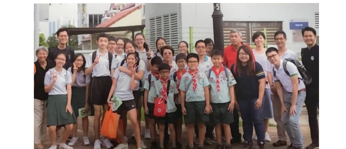 A group of primary school boy scouts posing with a group of secondary school students who are all volunteers to spread awareness to stamp out dengue